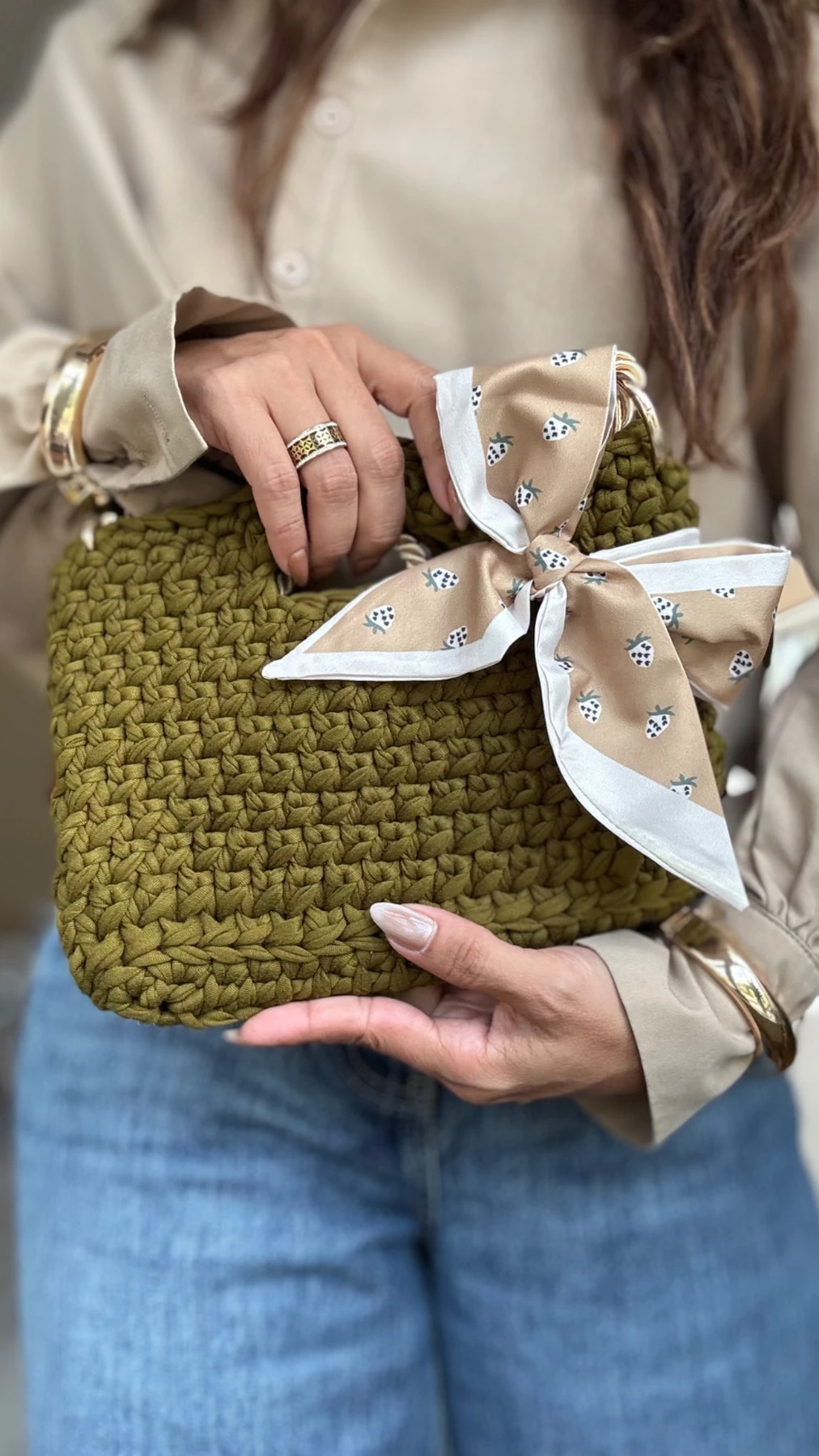 Handcrafted Encanto — Olive bag with a printed silk bow, satin-cord strap and gold-tone details.